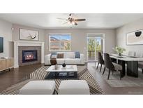 Living room featuring a fireplace, access to the patio, and modern furnishings at 12210 Pine Post Dr, Parker, CO 80138
