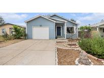 Charming home featuring a well-maintained lawn, a driveway, and a one-car garage at 309 Lincoln Ave, Platteville, CO 80651