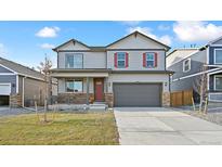 Two-story house with gray siding, red door, and attached garage at 27621 E Cedar Ave, Aurora, CO 80018