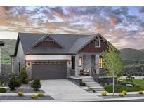 Charming single-Gathering home featuring stone accents, a two-car garage, and a welcoming front porch with mountain views at 138 S Seacrest St, Golden, CO 80401