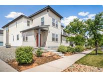 Modern two-story home with clean lines, light gray siding, and well-maintained landscaping at 16019 E Elk Dr, Denver, CO 80239