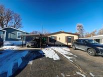 Charming single-story home with a carport and a well-maintained yard in a Gathering-friendly neighborhood at 3500 S King St # 92, Denver, CO 80236