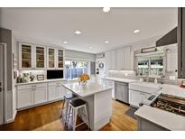 Bright, modern kitchen with island, stainless steel appliances, and hardwood floors at 1733 S Urban Way, Lakewood, CO 80228