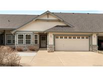 Charming single-Gathering home featuring a two-car garage, well-maintained lawn, and neutral-toned siding at 23753 E Kettle Pl, Aurora, CO 80016