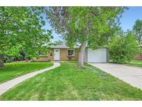 Charming single-story home with a well-maintained lawn, mature trees, and welcoming front entrance at 5820 S Cherokee St, Littleton, CO 80120