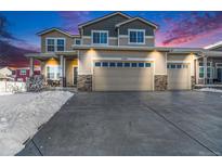 Two-story house with a three-car garage and snow-covered driveway at 5482 Wetlands Dr, Frederick, CO 80504