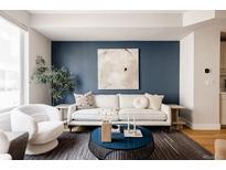 Bright living room features a comfy sofa and stylish coffee table at 1836 Grove St # 107, Denver, CO 80204