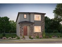 Charming two-story home with stone accents and a well-manicured front yard, perfect for curb appeal at 6322 N Malaya St, Aurora, CO 80019