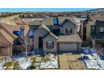 Two-story house with gray siding, a gray roof, and a landscaped yard at 10750 Fairbairn Way, Highlands Ranch, CO 80130