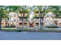 Charming condo complex with tan exterior, multiple balconies, and mature trees lining the street at 45 N Ogden St # 309, Denver, CO 80218