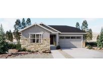 Charming single-story home featuring stone accents, a two-car garage, and professional landscaping at 21935 E 39Th Pl, Aurora, CO 80019