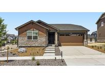 Charming single-Gathering home featuring a stone facade and a two-car garage at 21935 E 39Th Pl, Aurora, CO 80019