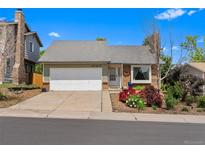 Charming single-story home with a well-manicured lawn and attached garage at 18771 Mexico E Dr, Aurora, CO 80017