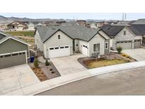Inviting two-story home featuring a spacious two-car garage, manicured landscaping, and a charming front entrance at 8985 Chalk Creek Pl, Littleton, CO 80125