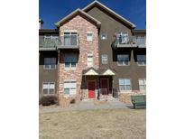 Attractive multi-story home with stone accents and balconies overlooking well manicured grounds at 18726 E Yale Cir # D, Aurora, CO 80013