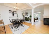 Bright dining room with modern light fixture, contemporary art, and open floor plan at 1747 N Washington St # C303, Denver, CO 80203