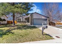 Charming single-Gathering home featuring a well-maintained lawn, two car garage, and cozy curb appeal at 9093 Dudley St, Westminster, CO 80021