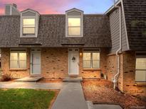 Charming brick townhome with well-maintained landscaping and a welcoming front entrance at 1517 S Owens St # 9, Denver, CO 80232