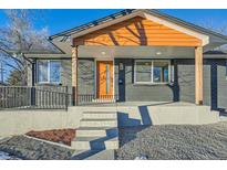 Updated Ranch home with modern facade, charming front porch, and gray brick exterior at 71 W Fremont Ave, Littleton, CO 80120