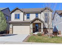 Charming two-story home with a well-maintained lawn, attached two-car garage, and attractive stone accents at 4783 S Wenatchee Cir, Aurora, CO 80015