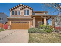 Charming two-story home featuring a well-maintained front yard and a two-car garage at 20229 E Red Fox Ln, Centennial, CO 80015