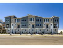 New townhome exteriors feature stone accents, gray siding, and modern architectural details in a contemporary design at 20578 E 63Rd Ave, Aurora, CO 80019