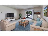 Comfortable living room featuring a plush sofa, armchair, and a coffee table on an area rug at 13606 E Bates Ave # 102, Aurora, CO 80014