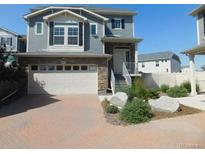 Charming two-story home with stone accents and a brick driveway, perfect for suburban living at 4551 N Quemoy St, Aurora, CO 80019