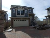 Charming two-story home with attached two-car garage and manicured landscaping at 4551 N Quemoy St, Aurora, CO 80019
