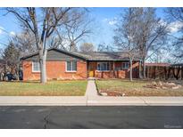 Charming brick ranch-style home with mature trees and a well-maintained front yard at 6255 W 43Rd Ave, Wheat Ridge, CO 80033