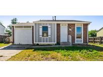 Charming single-story home features brick and siding, attached garage, and a well-maintained front yard at 5112 Duluth Ct, Denver, CO 80239