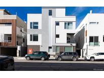 Modern multi-story home with mixed brick and siding, plus a tandem two car parking in front at 4551 Tennyson St, Denver, CO 80212
