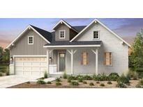 Charming two-story home with a brick and gray siding exterior and a two-car garage at 3394 Backdrop Ct, Castle Rock, CO 80108