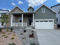 Charming two-story home featuring a covered porch and a two-car garage at 3394 Backdrop Ct, Castle Rock, CO 80108