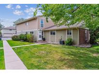 Charming home exterior with a well-manicured lawn and mature trees offering shade at 6650 E Arizona Ave # 154, Denver, CO 80224