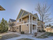 Charming townhome with a covered balcony, stone accents, and landscaped surroundings at 3230 Boulder Cir # 101, Broomfield, CO 80023