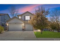 Charming stucco home with a three-car garage and well-maintained lawn at 11935 E Lake Ct, Greenwood Village, CO 80111