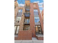 Modern brick condo with metal accents on a sunny day at 1012 Bannock St, Denver, CO 80204