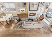 Bright living room with modern decor, a fireplace, and a dining area at 1012 Bannock St, Denver, CO 80204