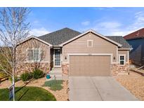 Charming single Gathering home showcasing a two-car garage and beautiful stone accents at 5900 Haywagon Ln, Castle Rock, CO 80108
