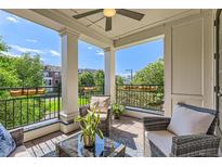 Inviting balcony featuring comfortable seating, a ceiling fan, and picturesque neighborhood views at 3411 N Xenia St, Denver, CO 80238