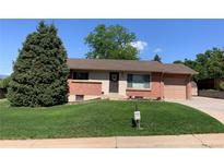Charming brick home with a well-maintained lawn and mature evergreen tree in a desirable neighborhood at 2797 S Newton Way, Denver, CO 80236