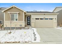 Charming single-story home featuring a two-car garage and a welcoming front entrance with stone accents at 3887 Grand Baker St, Aurora, CO 80019