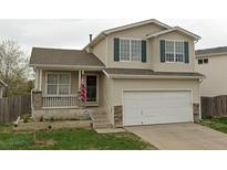 Charming two-story home featuring a front porch, two-car garage, and classic architectural details at 19524 Montview Dr, Aurora, CO 80011