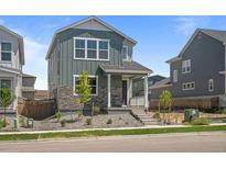 Charming two-story home featuring stone accents and manicured landscaping at 20871 E 60Th Ave, Aurora, CO 80019