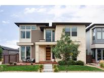 Modern two-story home with stone accents and a landscaped front yard at 9385 E 58Th Dr, Denver, CO 80238