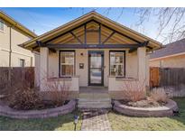 Charming bungalow featuring a well-manicured front yard with a brick pathway and quaint architectural details at 2470 Meade St, Denver, CO 80211