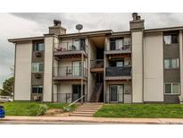 Attractive multi-story condo building with private balconies and well-maintained landscaping at 2280 S Oswego Way # 303, Aurora, CO 80014