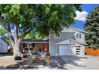 Charming home with a mix of brick and siding, mature trees, a front yard, and an attached two car garage at 2117 S Balsam Ct, Lakewood, CO 80227