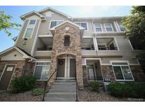 Beautiful condo building featuring stone accents, covered balconies, and well-maintained landscaping at 12711 Colorado Blvd # 914, Thornton, CO 80241